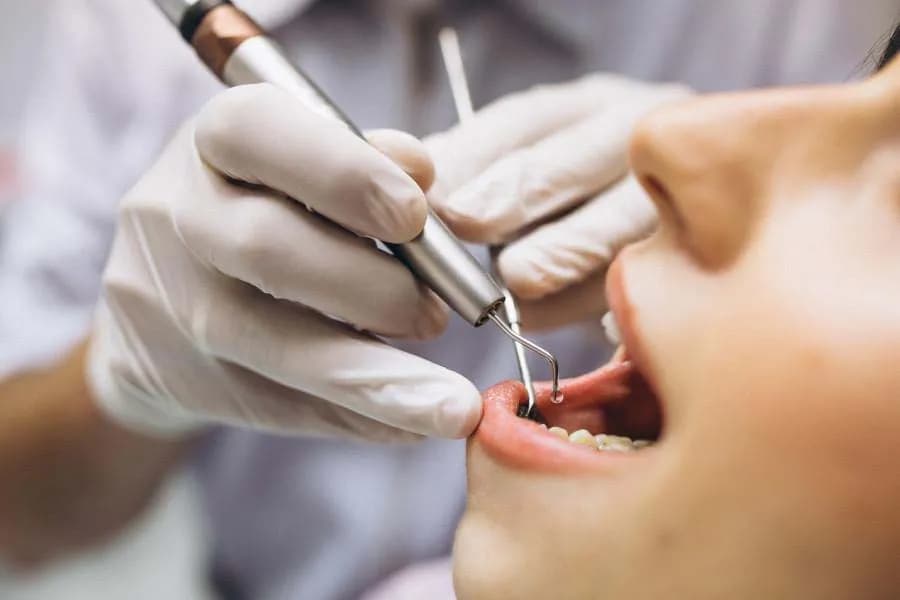 Dentist providing urgent emergency dental examination