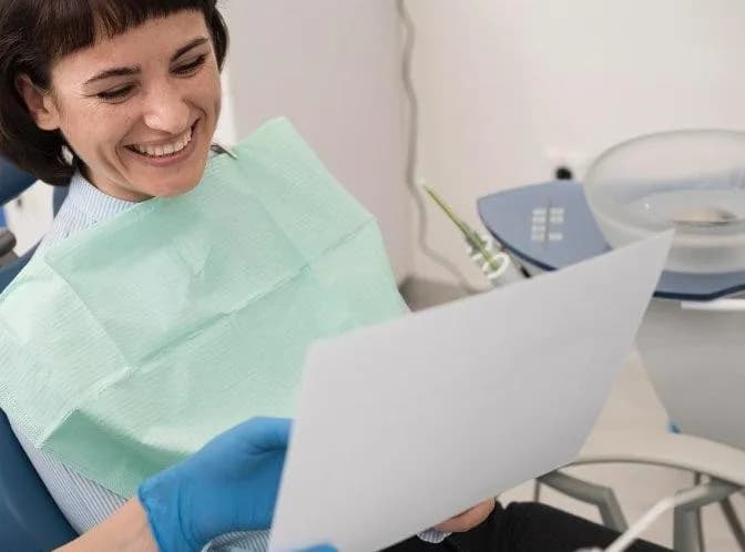 Dentist discussing treatment plan with patient using tablet