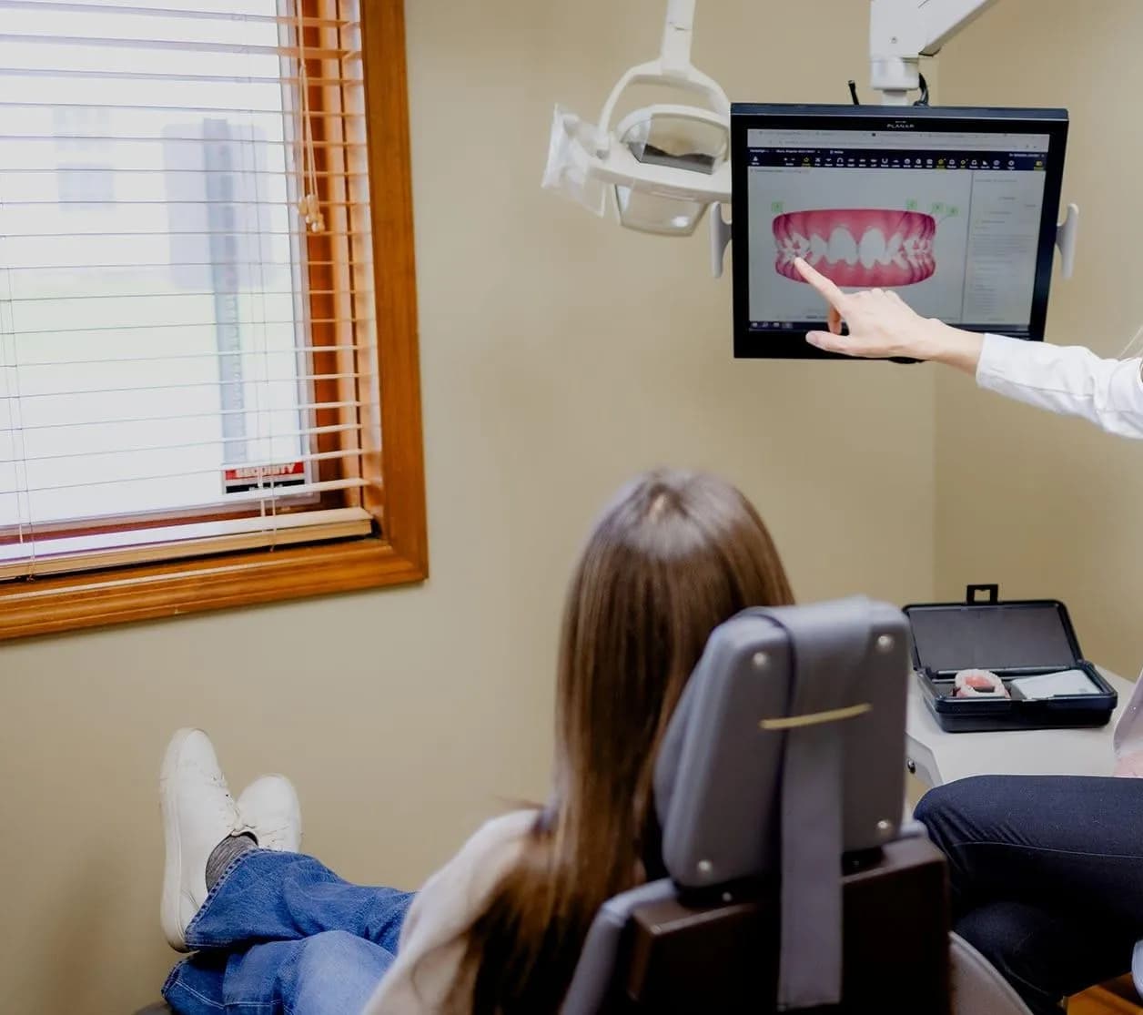 Dentist evaluating patient for laser dentistry treatment
