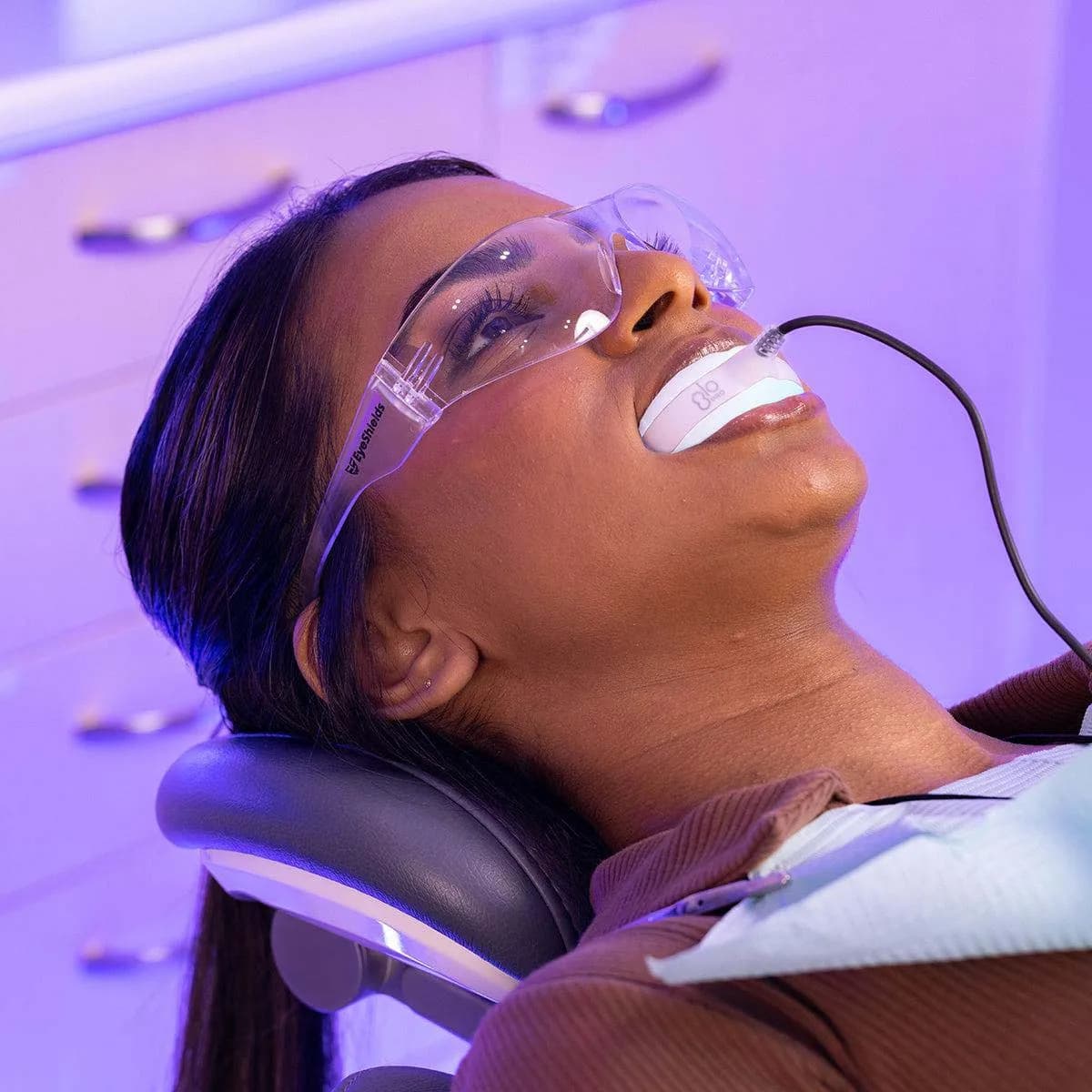 Patient receiving professional teeth whitening treatment